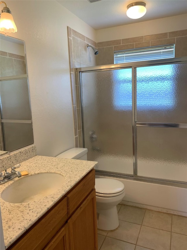 full bathroom featuring shower / bath combination with glass door, toilet, tile flooring, and oversized vanity