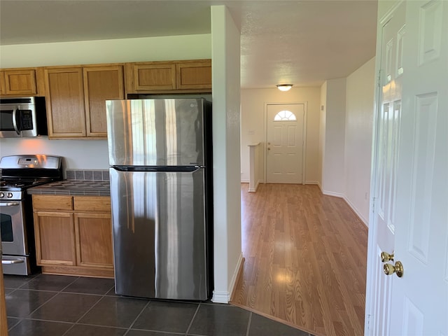 kitchen featuring stainless steel appliances and dark hardwood / wood-style floors