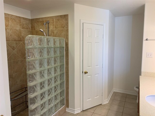 bathroom featuring tile flooring, vanity, and toilet