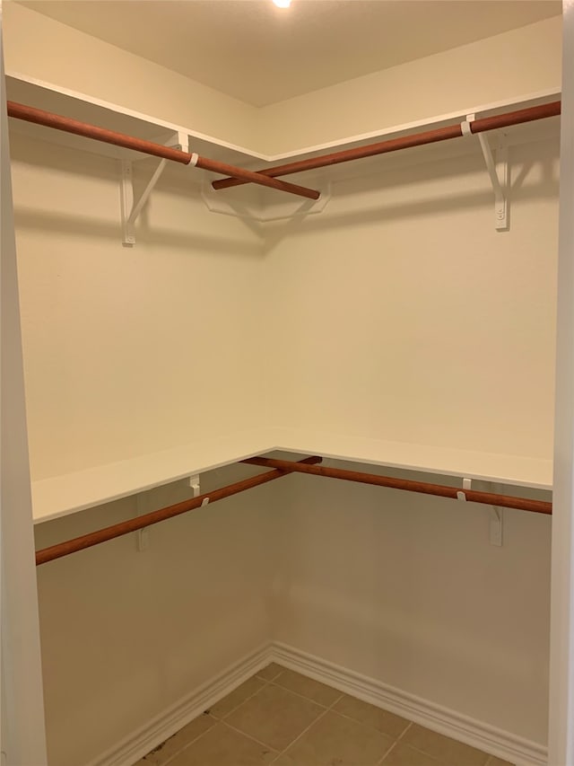 spacious closet featuring tile floors