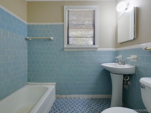 bathroom featuring tile floors, tasteful backsplash, toilet, and tile walls