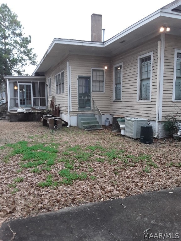 back of house featuring central air condition unit