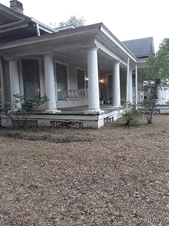 view of property exterior with a porch