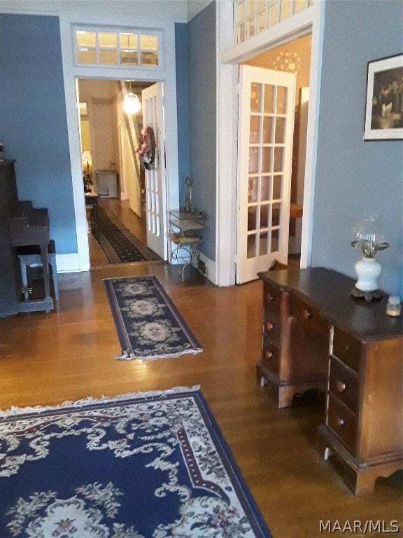 interior space with dark hardwood / wood-style floors and french doors
