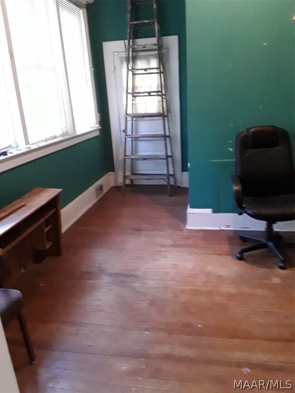 home office with dark hardwood / wood-style flooring
