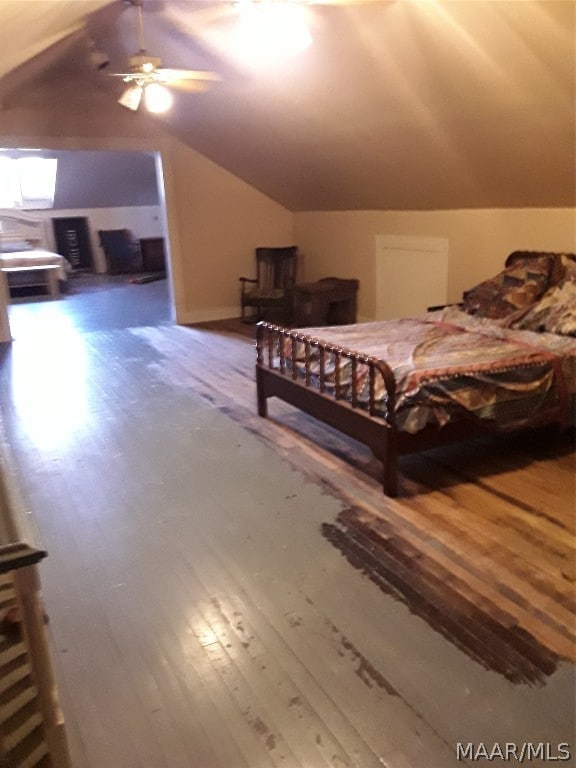 bedroom featuring lofted ceiling, dark wood-type flooring, and ceiling fan