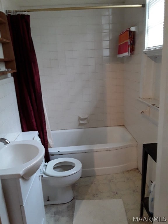 full bathroom featuring tile floors, toilet, vanity, and shower / tub combo