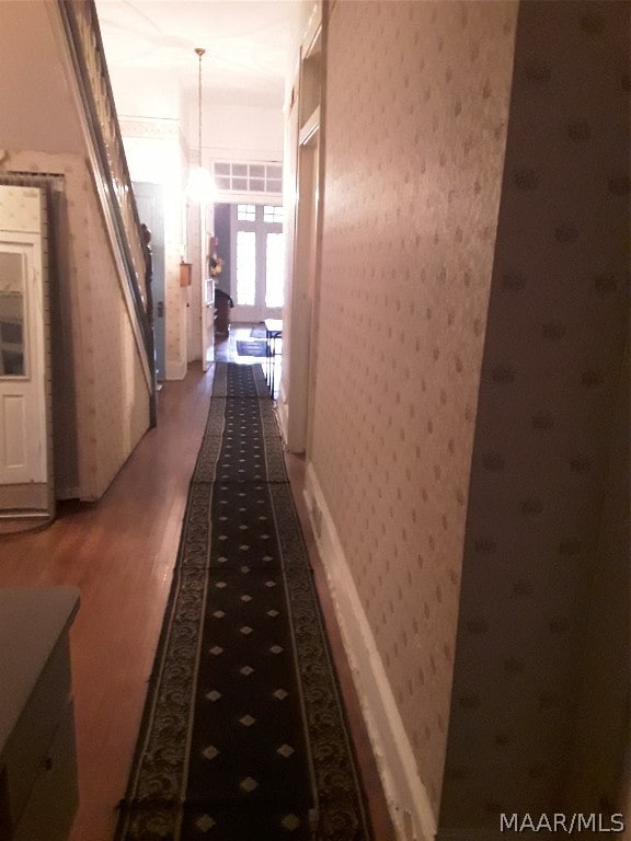hallway with dark hardwood / wood-style flooring