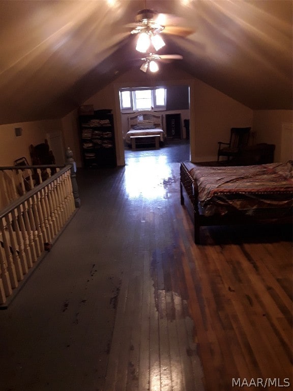 bedroom with vaulted ceiling, ceiling fan, and dark hardwood / wood-style flooring