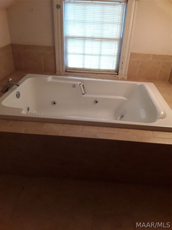 bathroom with a relaxing tiled bath