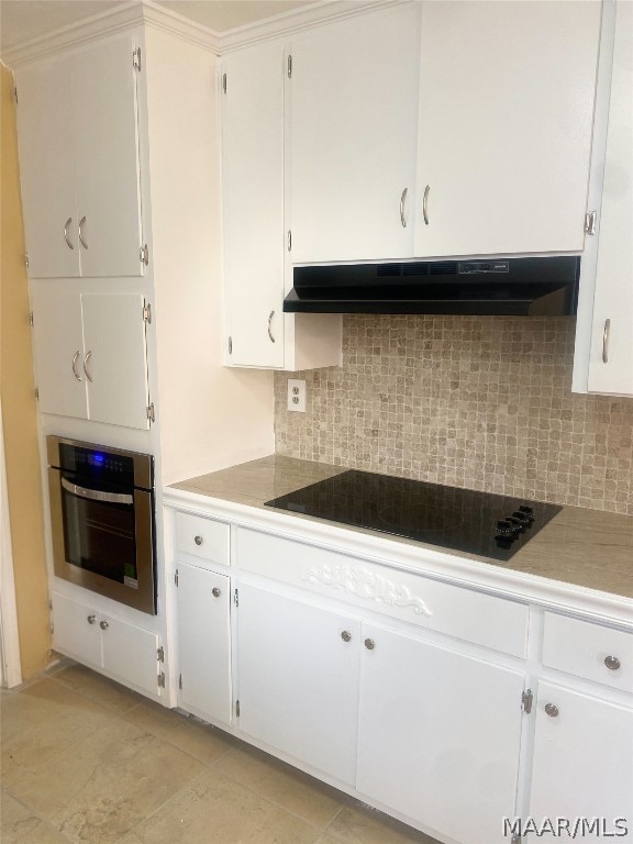 kitchen with stainless steel oven, black electric stovetop, white cabinetry, light tile floors, and backsplash