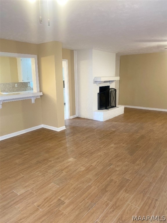 unfurnished living room featuring light hardwood / wood-style floors and a fireplace