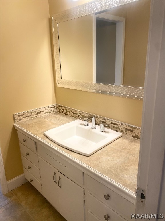 bathroom with backsplash, tile floors, and vanity