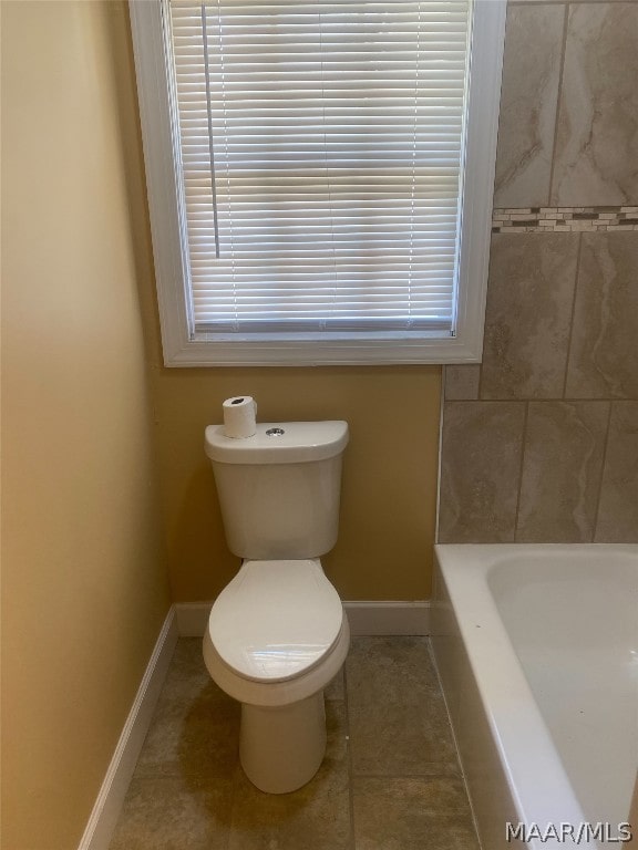 bathroom featuring toilet and tile floors