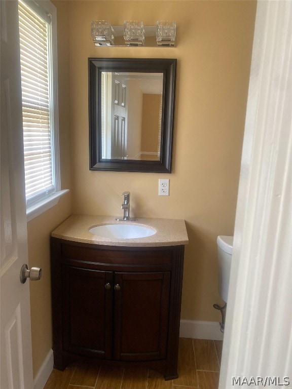 bathroom featuring toilet and vanity