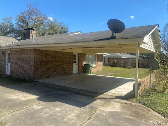 view of vehicle parking with a lawn and a carport