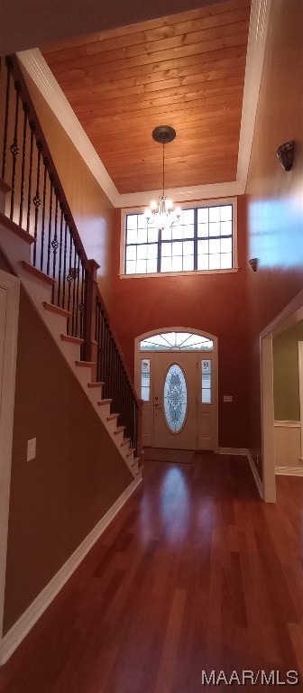 entryway featuring wooden ceiling, a healthy amount of sunlight, a chandelier, and wood-type flooring