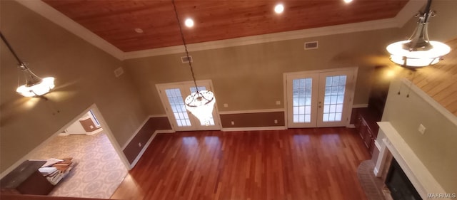 unfurnished living room with dark hardwood / wood-style flooring, french doors, wooden ceiling, and ornamental molding