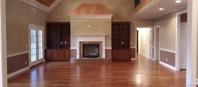 unfurnished living room with crown molding, dark hardwood / wood-style floors, and a brick fireplace