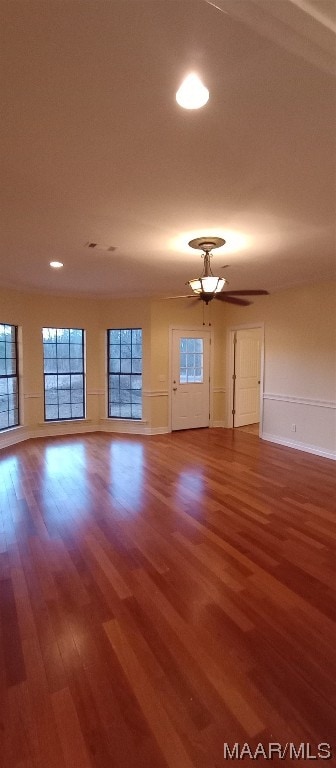 empty room featuring wood-type flooring and ceiling fan