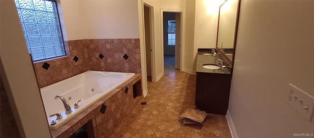 bathroom featuring vanity, a bath to relax in, and tile flooring