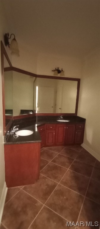 bathroom featuring tile flooring and dual sinks