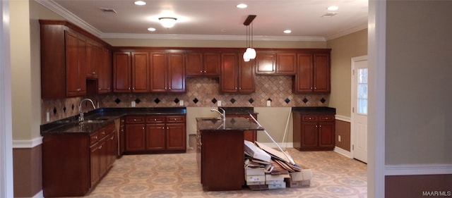 kitchen with decorative light fixtures, backsplash, light tile flooring, sink, and a center island