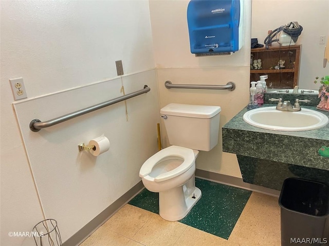 bathroom with toilet, tile flooring, and large vanity