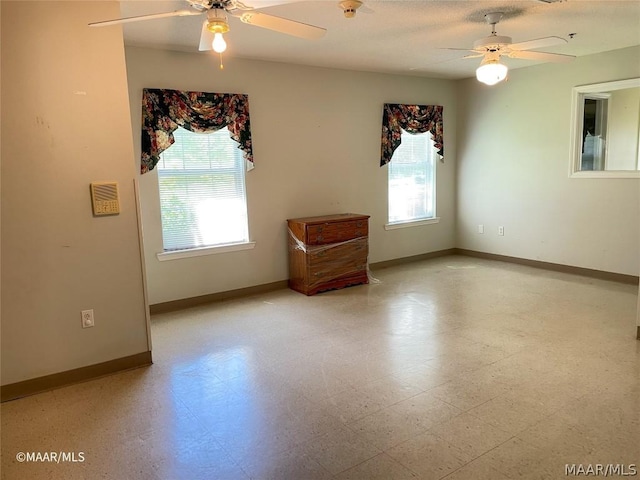 tiled spare room with ceiling fan and plenty of natural light