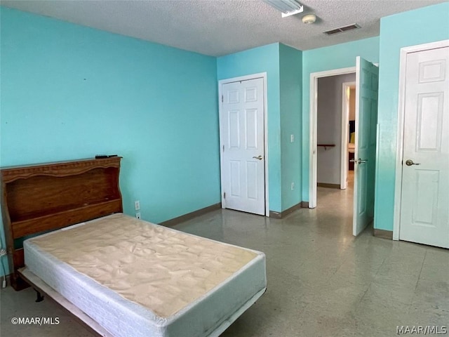 bedroom featuring billiards, a textured ceiling, and a closet