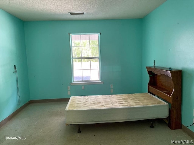 bedroom featuring a textured ceiling