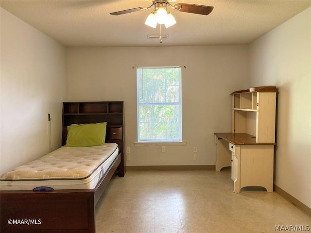 bedroom featuring ceiling fan and light tile floors