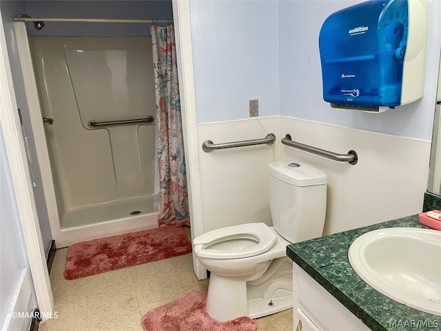 bathroom featuring toilet, tile floors, a shower with shower curtain, and vanity