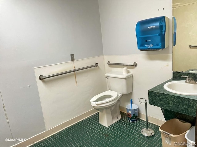 bathroom featuring toilet, tile flooring, and large vanity