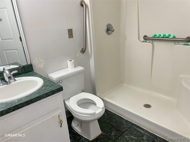 bathroom featuring a shower, tile floors, toilet, and oversized vanity