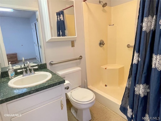 bathroom featuring toilet, vanity with extensive cabinet space, tile floors, and walk in shower