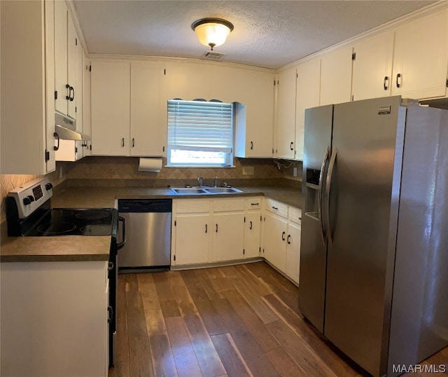 kitchen featuring dark wood-type flooring, appliances with stainless steel finishes, and white cabinetry