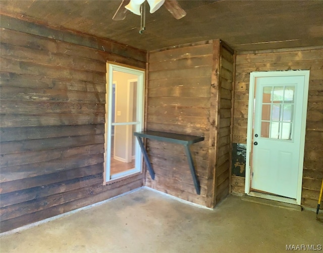 doorway to property featuring ceiling fan