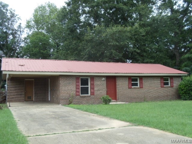 ranch-style home with a carport and a front yard