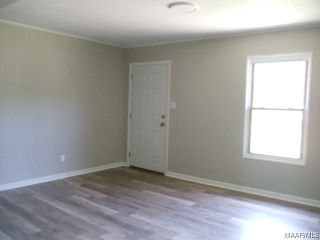 unfurnished room featuring dark hardwood / wood-style floors and a healthy amount of sunlight