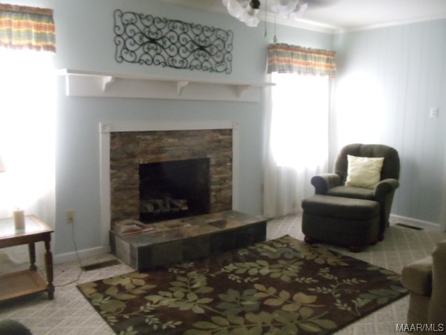 living room featuring ornamental molding and a fireplace