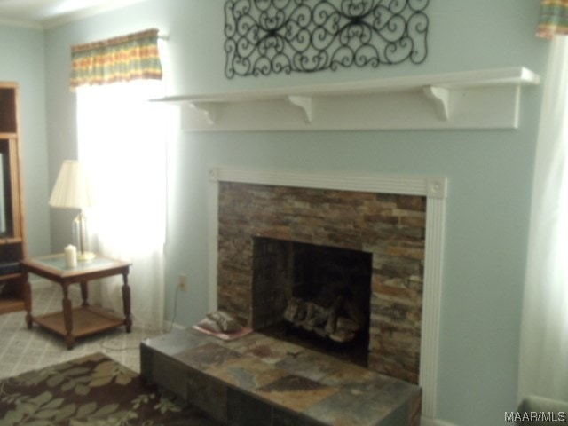 living room featuring a stone fireplace