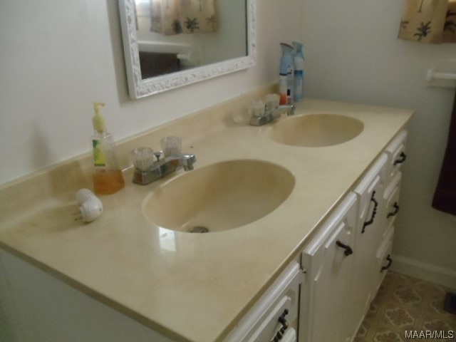 bathroom featuring dual sinks and large vanity