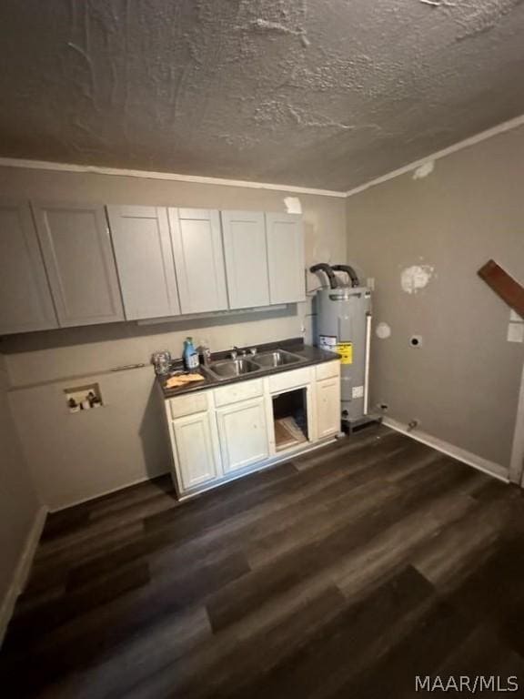 kitchen featuring sink, white cabinets, water heater, dark hardwood / wood-style floors, and crown molding