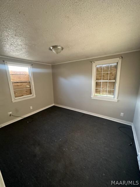 spare room with a textured ceiling