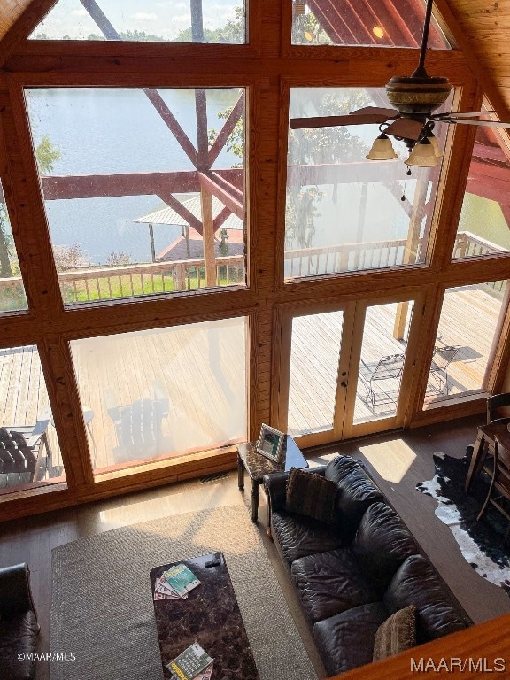 living room featuring french doors, ceiling fan, vaulted ceiling with beams, and hardwood / wood-style flooring