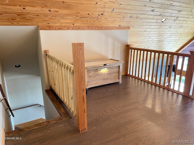 stairway featuring wood ceiling, lofted ceiling, and dark hardwood / wood-style floors