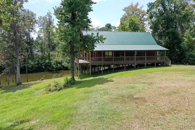 view of yard with a deck with water view