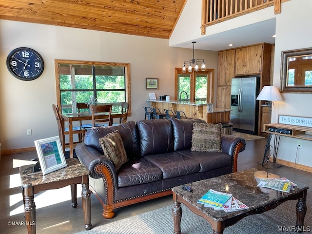 living room with dark wood-type flooring, sink, high vaulted ceiling, a chandelier, and wooden ceiling