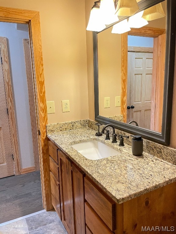 bathroom featuring large vanity and hardwood / wood-style flooring